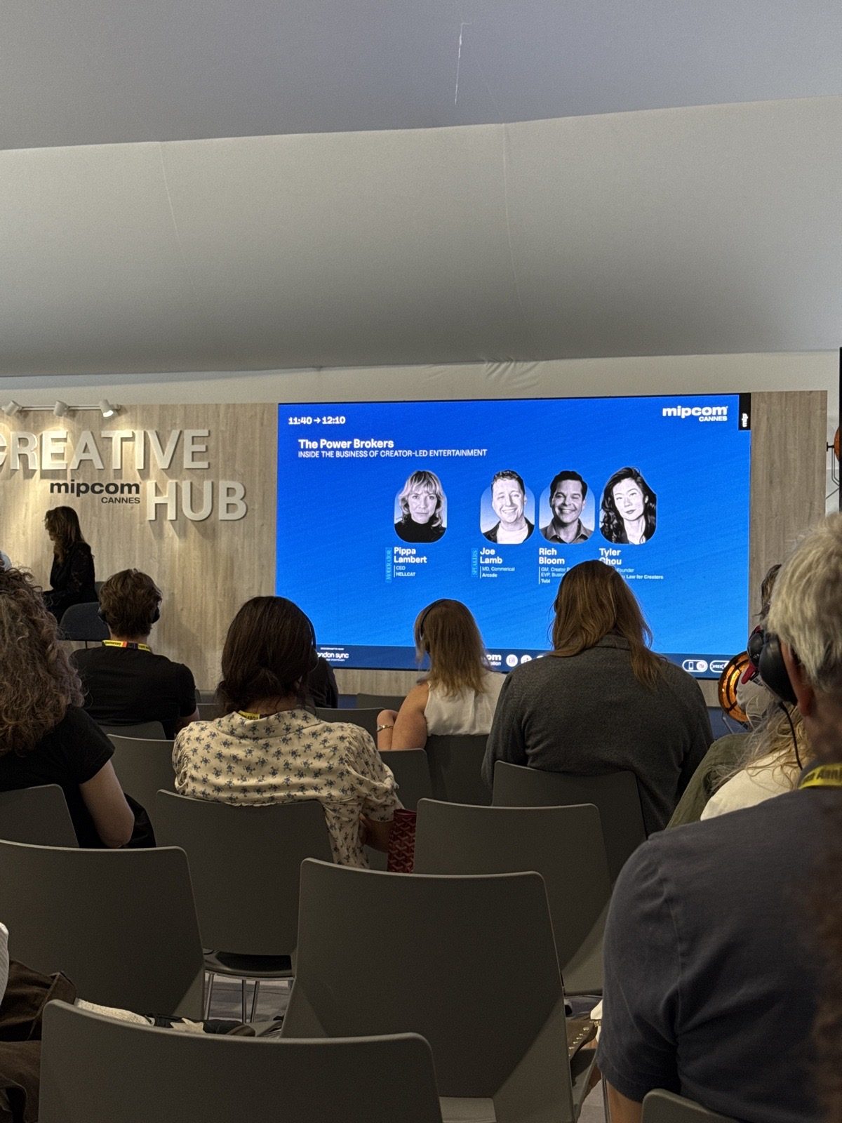 Audience in the MIPCOM Creative Hub facing a screen announcing 'The Power Brokers' panel
